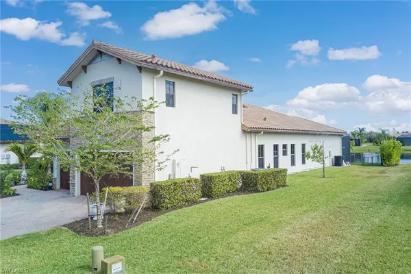 a view of a patio with a table and chairs under an umbrella