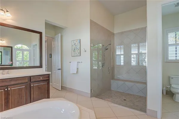 a bathroom with a shower sink and mirror
