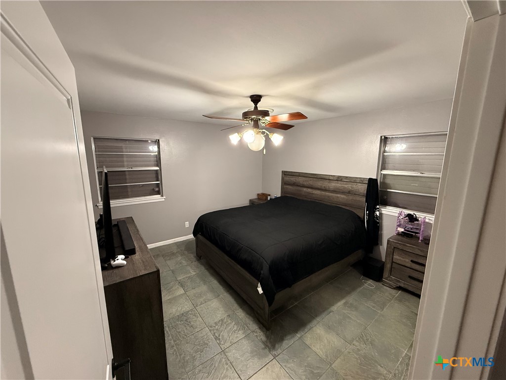 3504 Erwin Avenue Victoria, TX 77901 - Photo 13 of 16 a bedroom with a bed and a chandelier