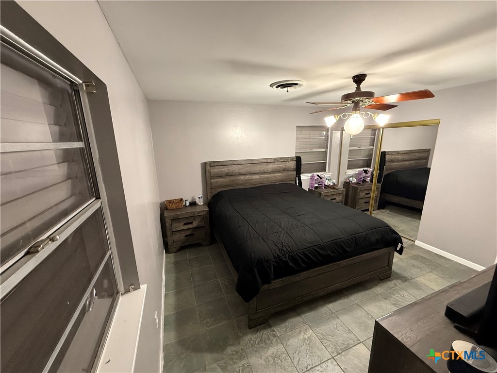 3504 Erwin Avenue Victoria, TX 77901 - Photo 14 of 16 a bedroom with a bed and a mirror