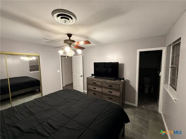 a bedroom with a bed and a flat screen tv