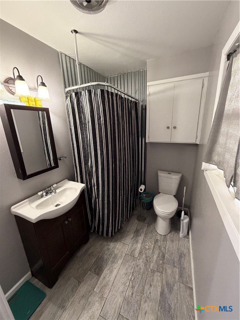 3504 Erwin Avenue Victoria, TX 77901 - Photo 16 of 16 a bathroom with a sink toilet and mirror