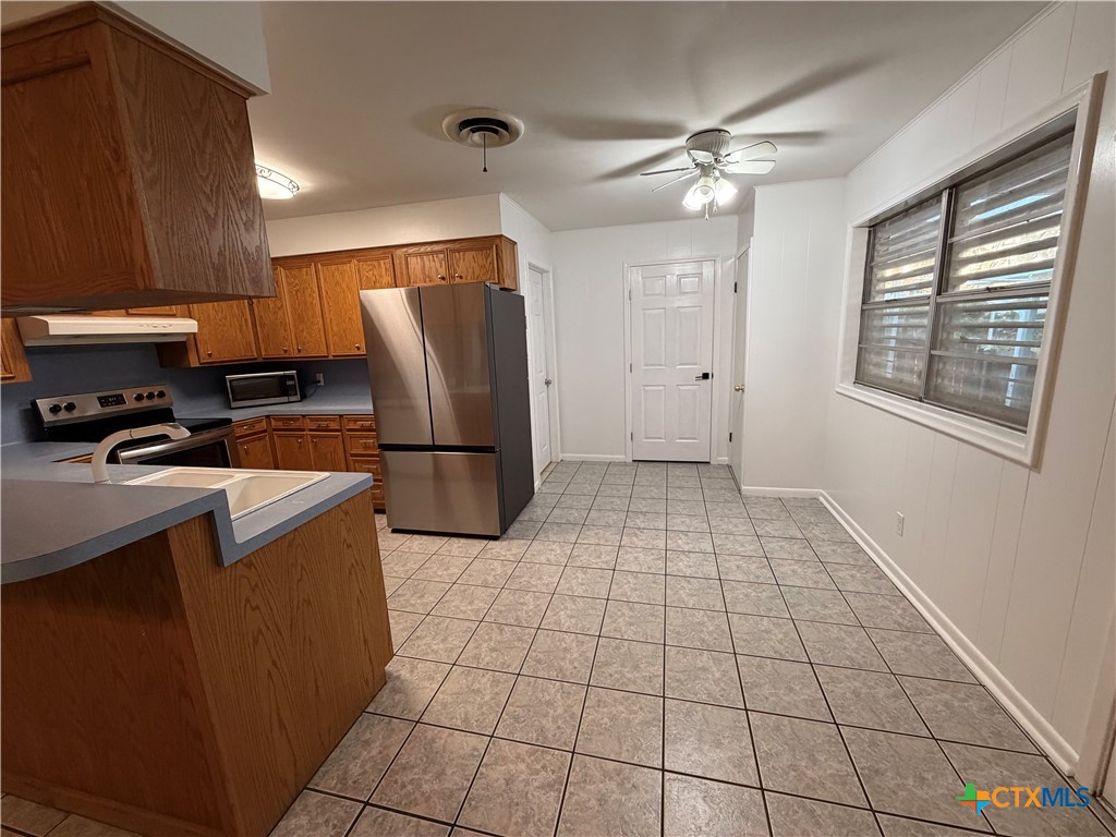 3504 Erwin Avenue Victoria, TX 77901 - Photo 4 of 16 a kitchen with stainless steel appliances granite countertop a refrigerator and a stove top oven