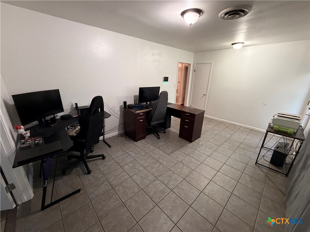 3504 Erwin Avenue Victoria, TX 77901 - Photo 7 of 16 a view of workspace with wooden floor and gym equipment