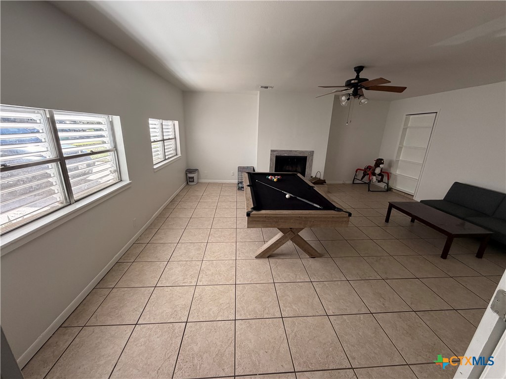 3504 Erwin Avenue Victoria, TX 77901 - Photo 9 of 16 a living room with furniture a floor to ceiling window and a table