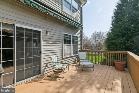 a view of a balcony with wooden floor and fence