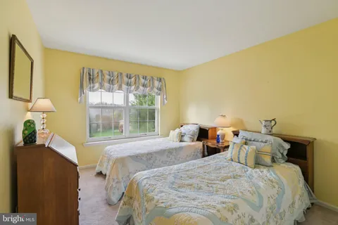 a bedroom with double bed and a window