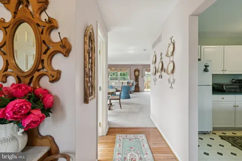 a view of a hallway view with wooden floor and living room