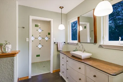 a view of a room with wooden floor fan and window