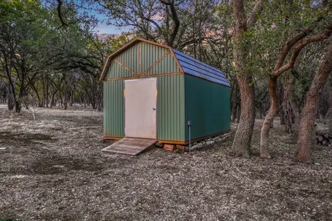 a view of outdoor space with trees all around