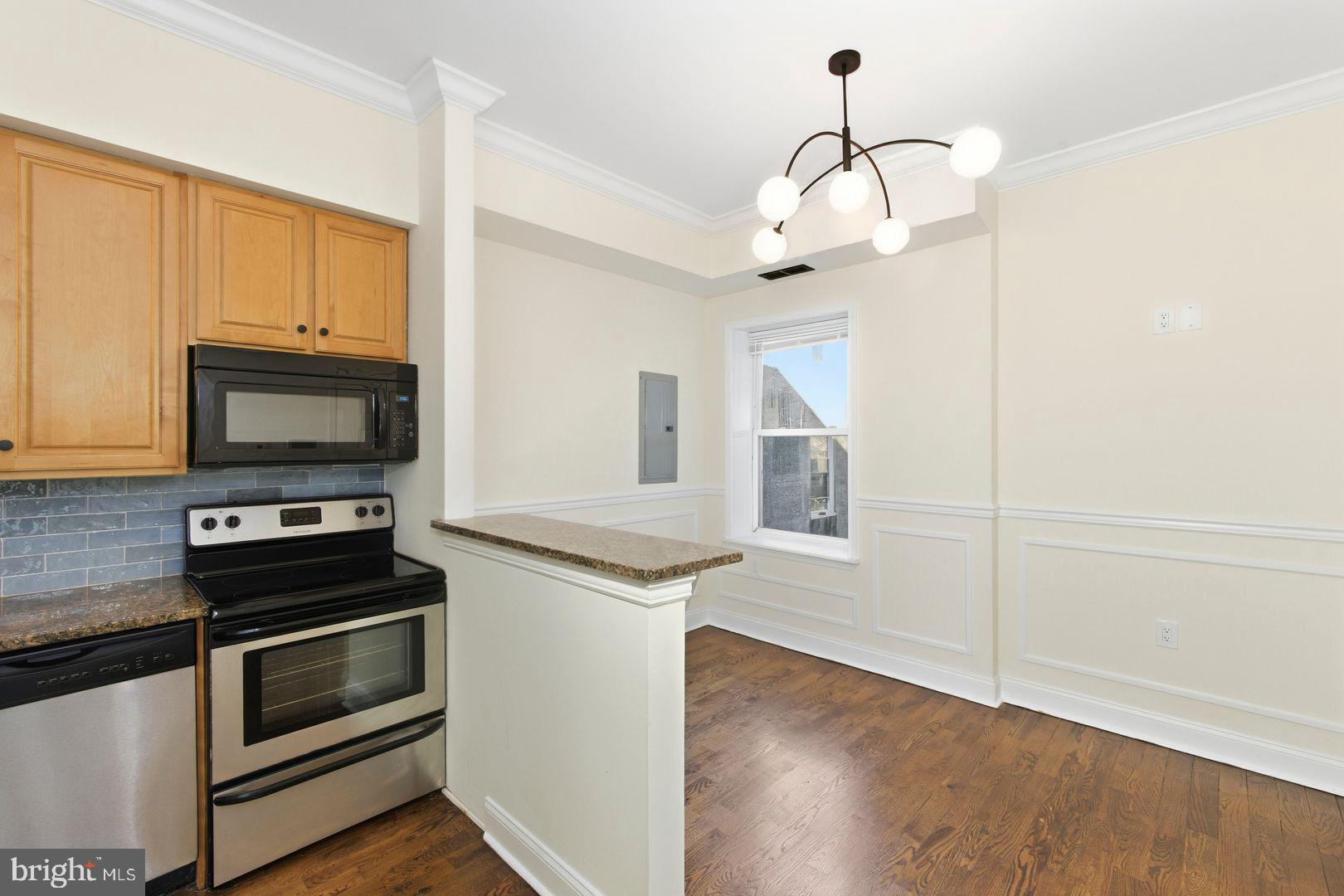 a kitchen with stainless steel appliances granite countertop a stove and a microwave