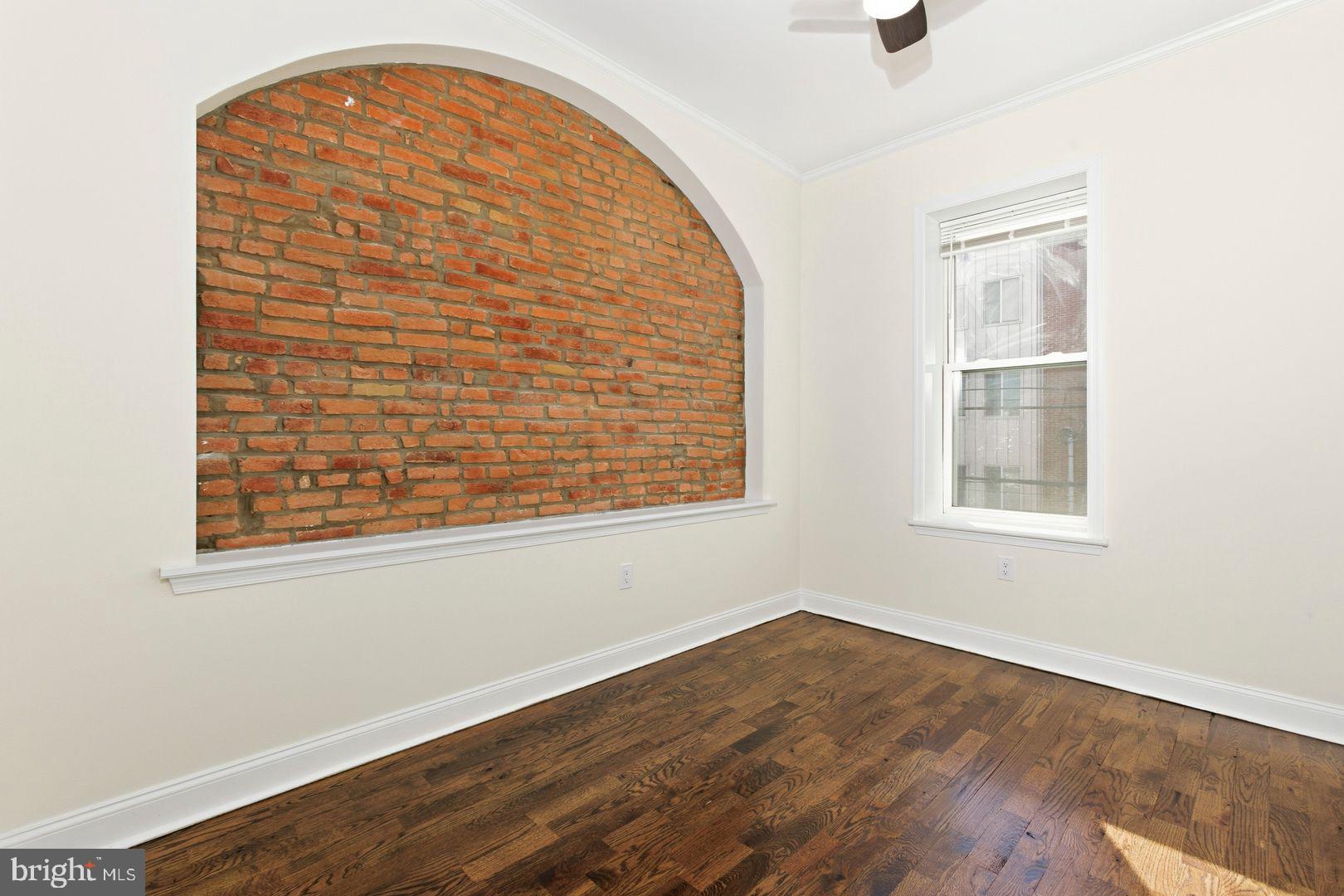 1723-0 Master Street, Unit D Philadelphia, PA 19121 - Photo 13 of 23 an empty room with wooden floor and windows