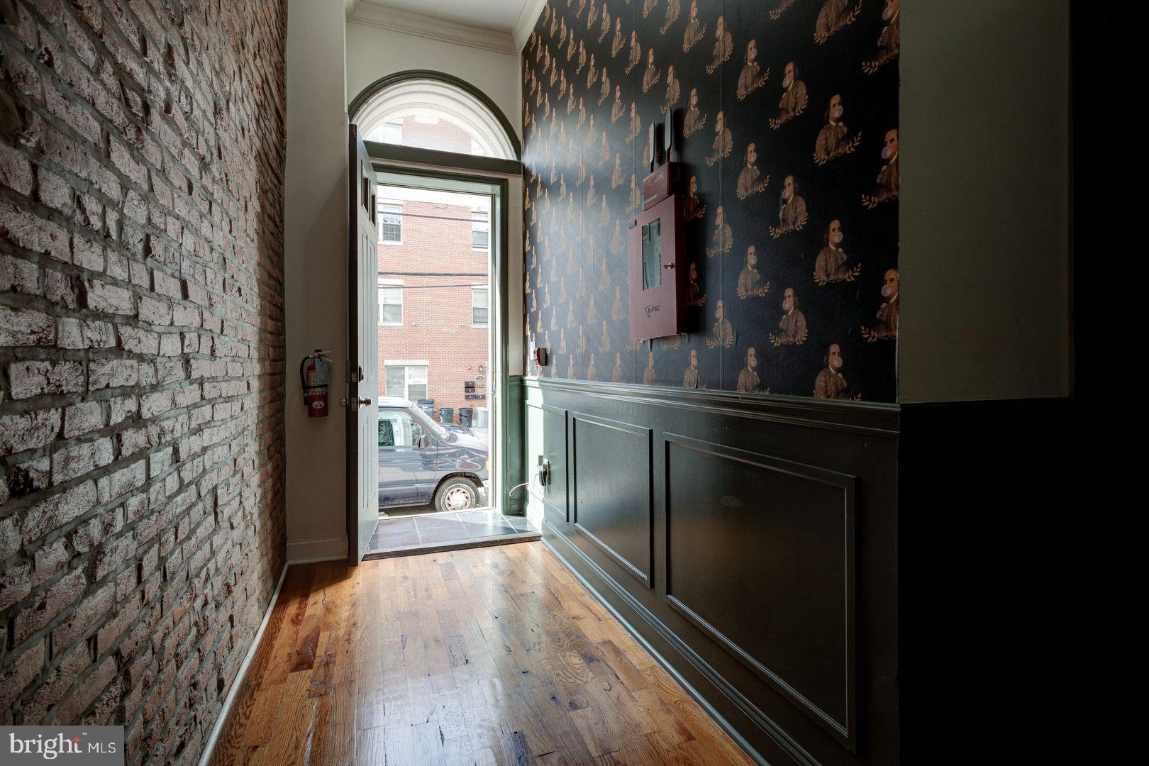 1723-0 Master Street, Unit D Philadelphia, PA 19121 - Photo 17 of 23 a view of a hallway to a livingroom with furniture