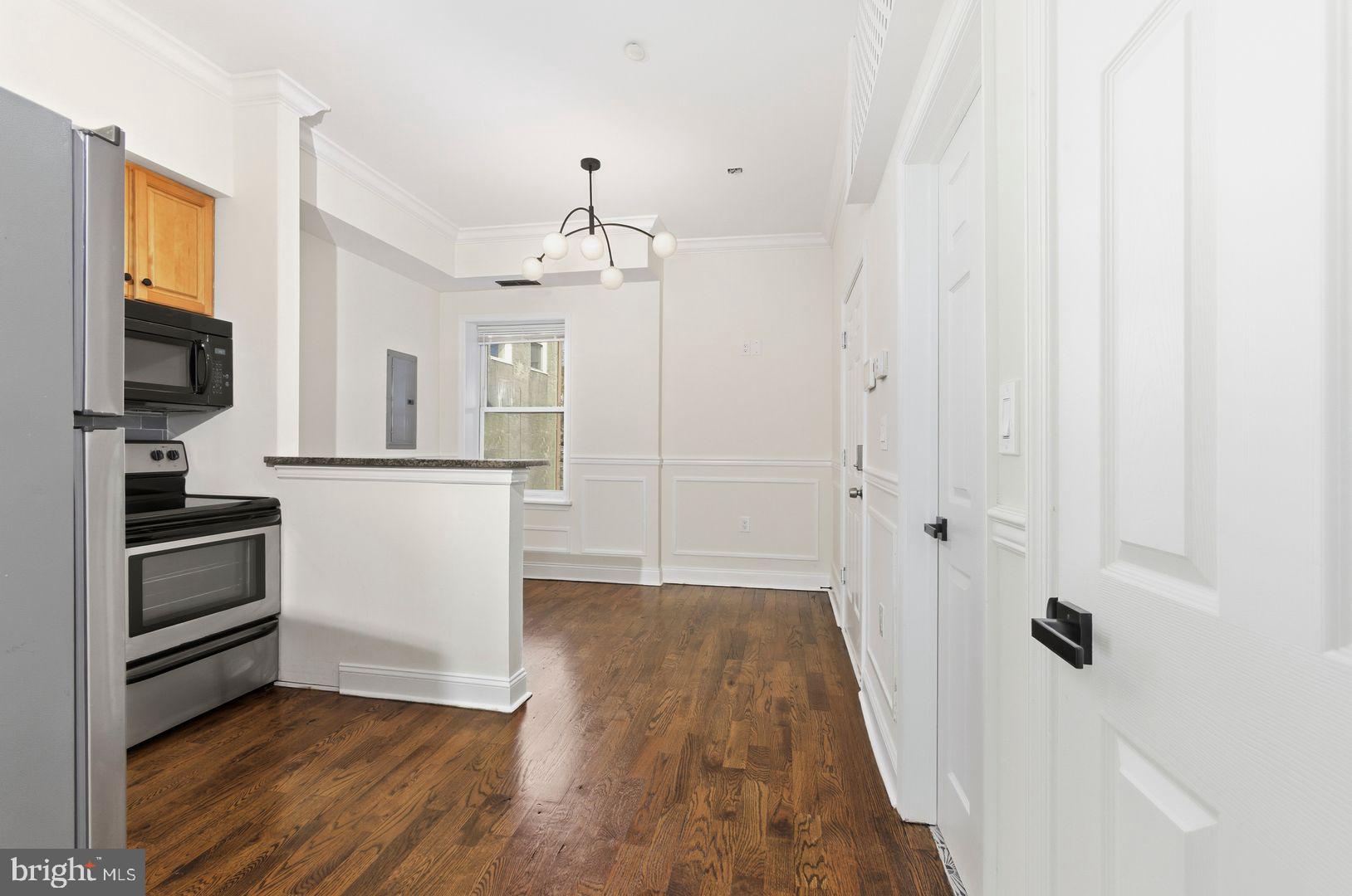 1723-0 Master Street, Unit D Philadelphia, PA 19121 - Photo 2 of 23 a view of a kitchen with wooden floor and electronic appliances