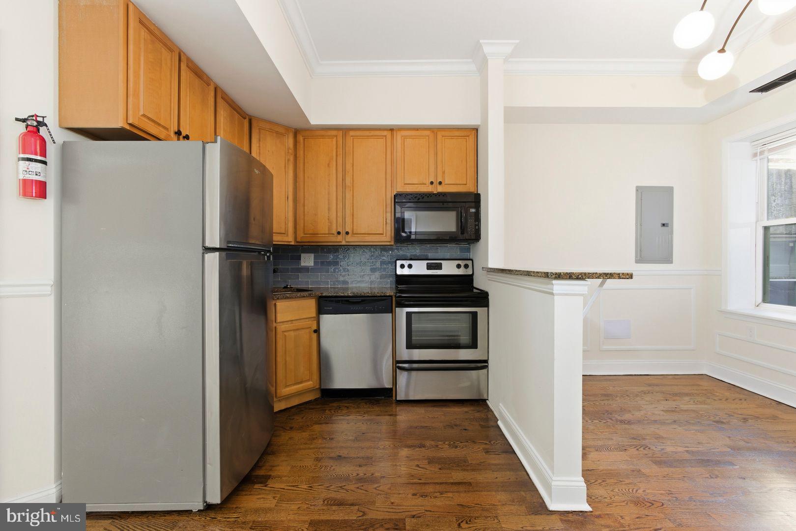 1723-0 Master Street, Unit D Philadelphia, PA 19121 - Photo 23 of 23 a kitchen with granite countertop a refrigerator and a stove