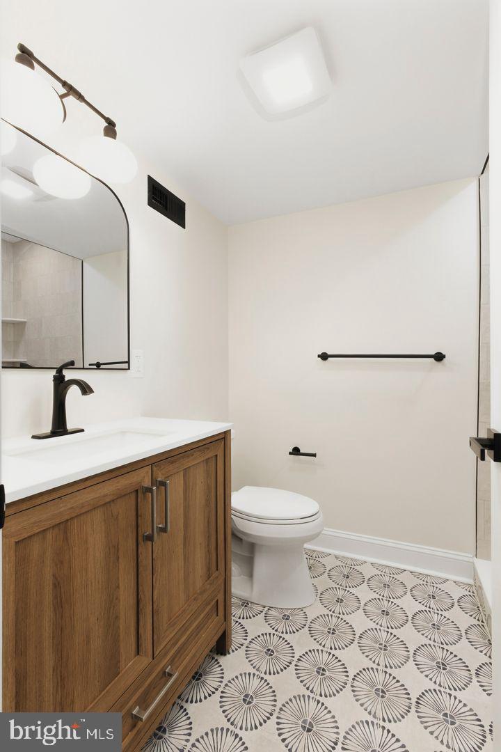 1723-0 Master Street, Unit D Philadelphia, PA 19121 - Photo 9 of 23 a bathroom with a sink a toilet and vanity