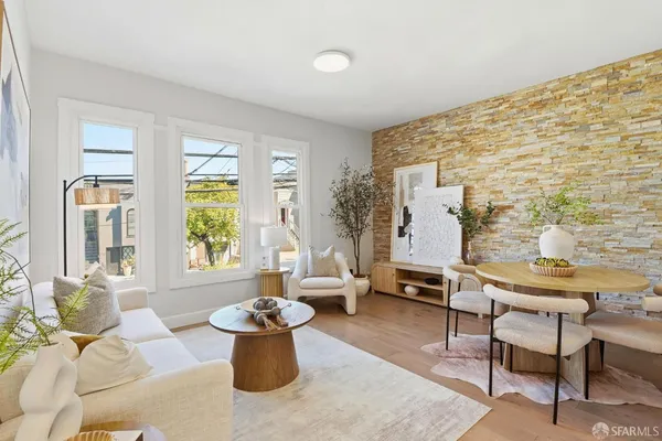 a living room with furniture and floor to ceiling windows