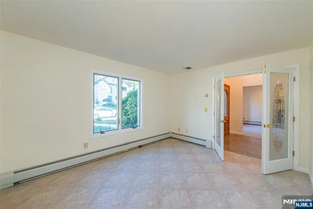 an empty room with a empty space and windows