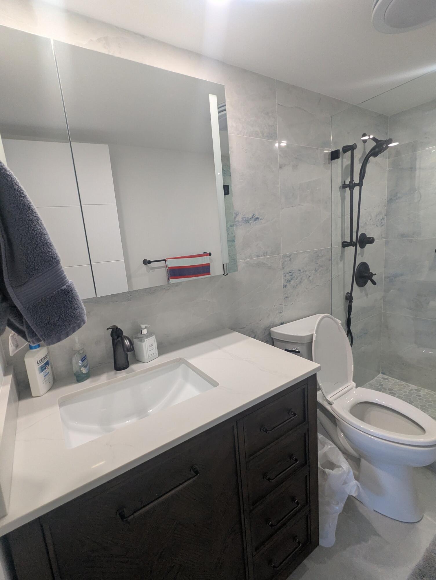 2121 North Ocean Boulevard, Unit 1006E Boca Raton, FL 33431 - Photo 42 of 64 a bathroom with a sink toilet vanity and tub