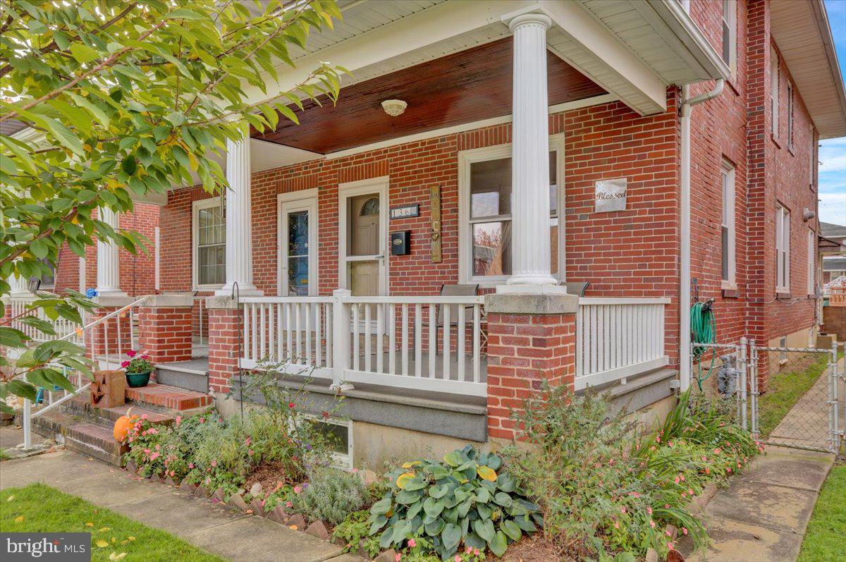 136 West Elm Street Reading, PA 19607 - Photo 2 of 23 a front view of a house with a garden