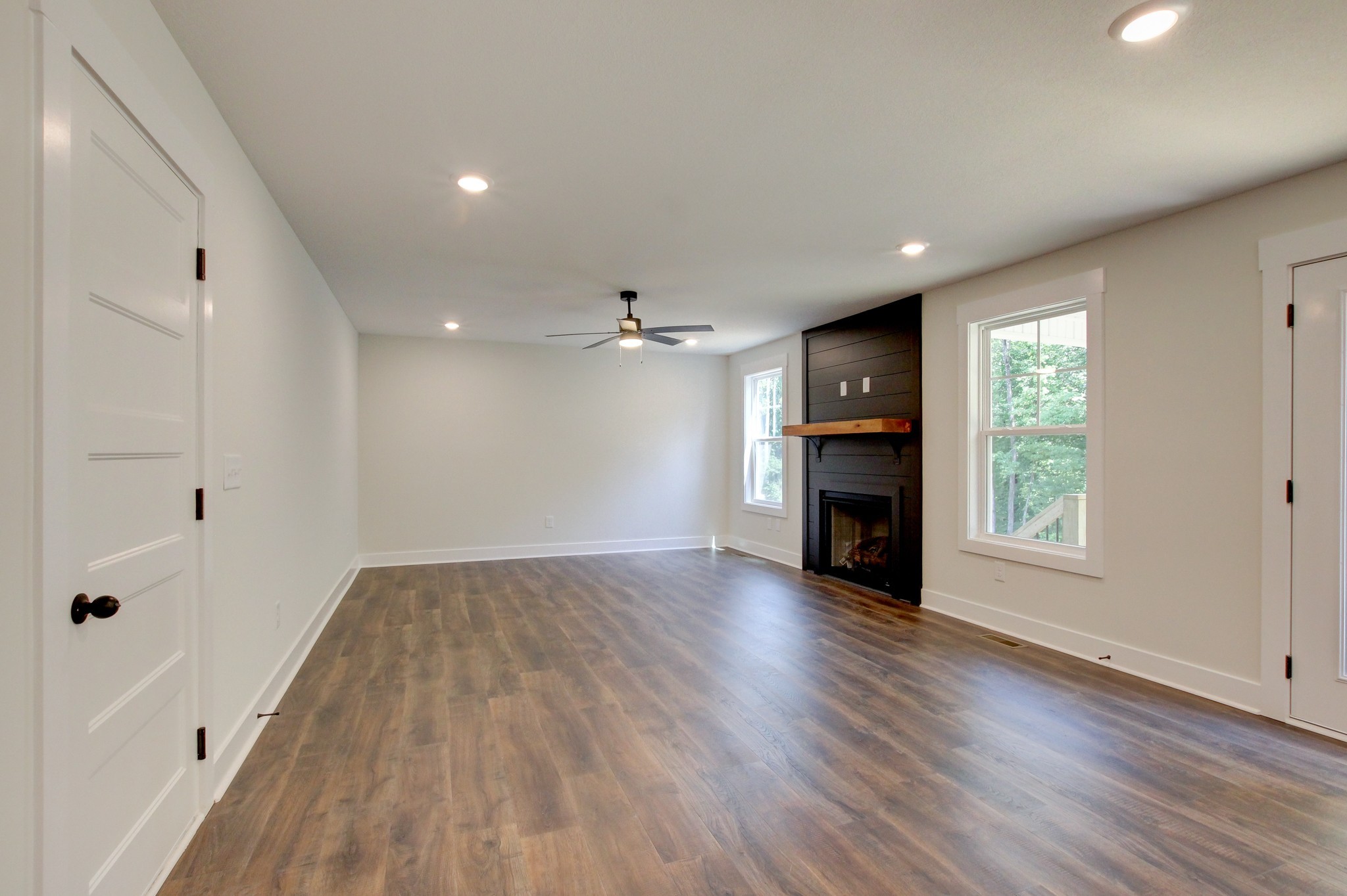 1244 Boulder Pass Road Clarksville, TN 37040 - Photo 11 of 31 an empty room with wooden floor fireplace and windows