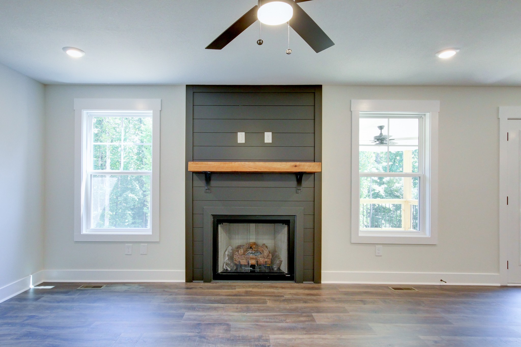 1244 Boulder Pass Road Clarksville, TN 37040 - Photo 12 of 31 a living room with a fireplace and wooden floor