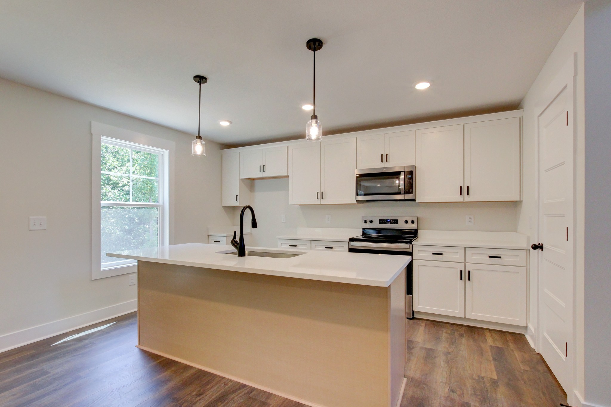 1244 Boulder Pass Road Clarksville, TN 37040 - Photo 6 of 31 a kitchen with stainless steel appliances granite countertop a sink a stove a refrigerator and white cabinets with wooden floor