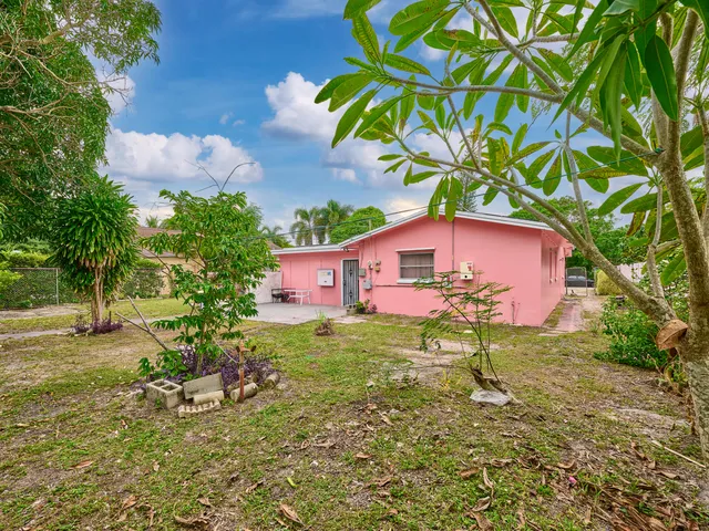 a backyard of a house with table and chairs