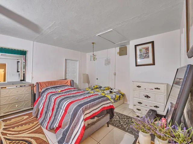 a bedroom with two beds and a chandelier