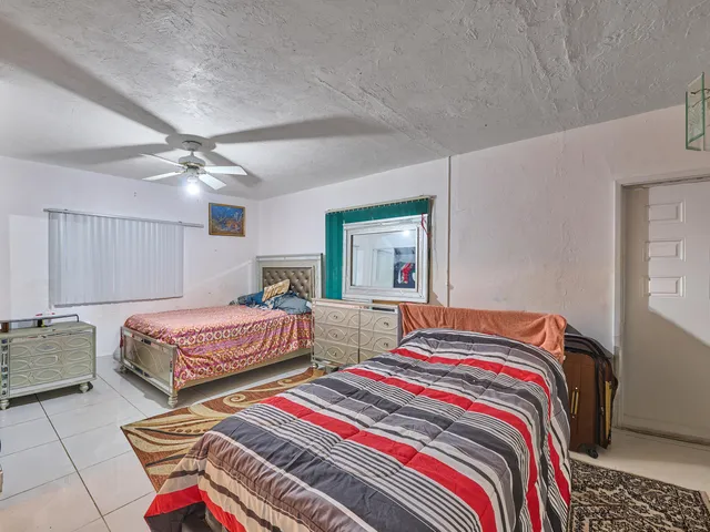 a bedroom with a bed and a television