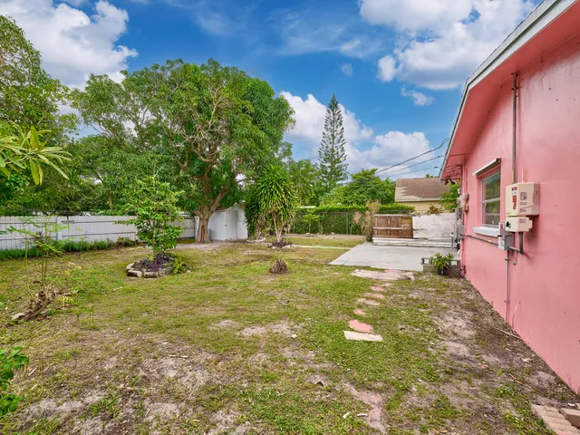 a view of yard with swimming pool and trees