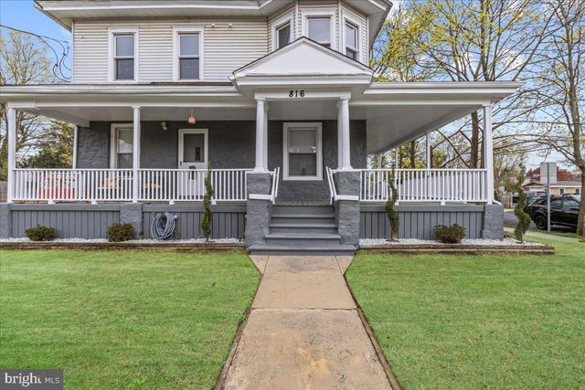 a view of living room with furniture and wooden floor