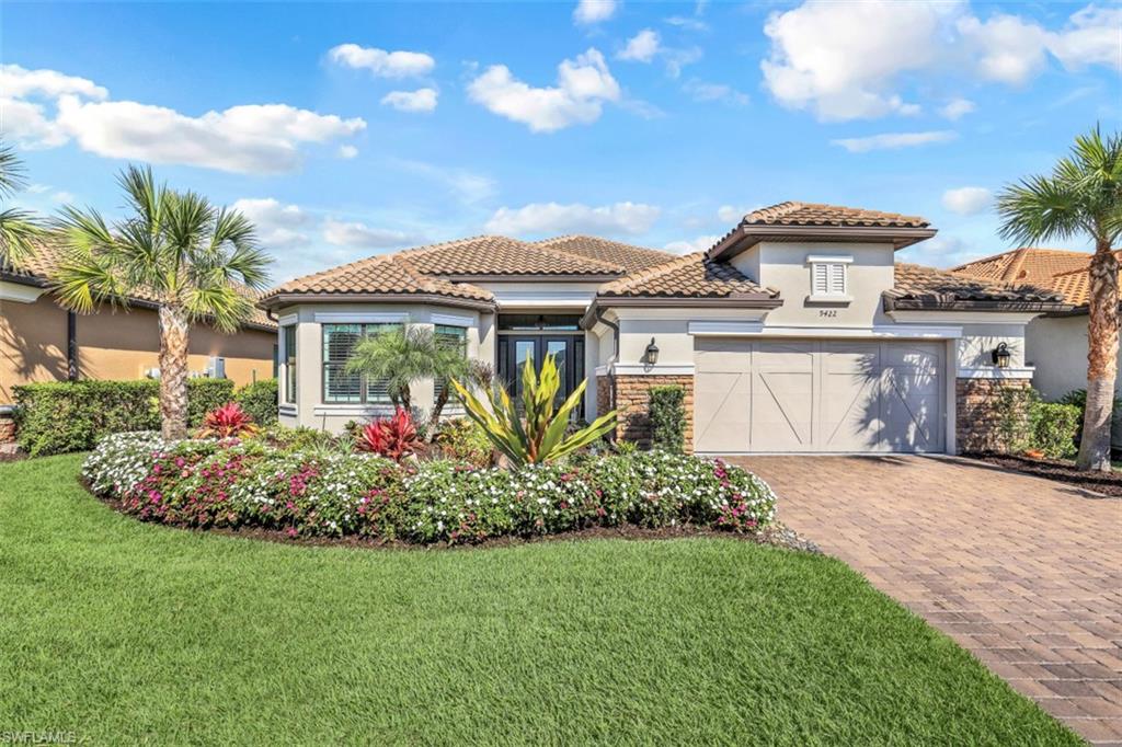 9422 Galliano Terrace Naples, FL 34119 - Photo 1 of 38 a front view of a house with a garden