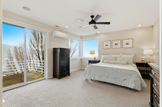 1878 East Ridge Point Drive Bountiful, UT 84010 - Photo 21 of 92 Bedroom with light carpet, access to exterior, and ceiling fan