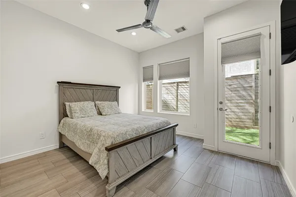 a kitchen with kitchen island stainless steel appliances a sink cabinets and wooden floor
