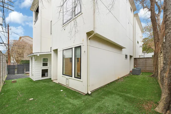 a bedroom with a bed window and wooden floor