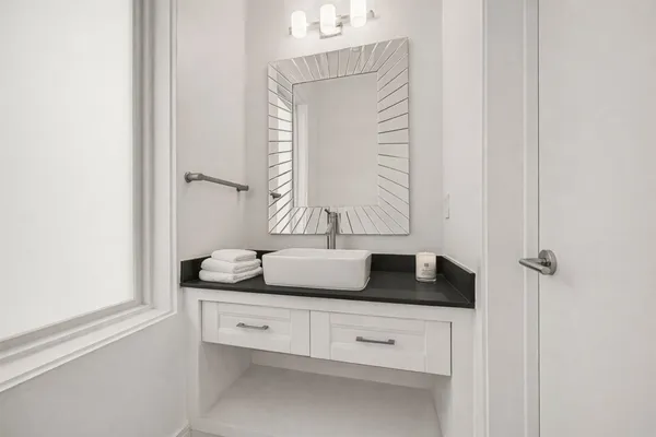 a bathroom with a granite countertop sink toilet a mirror a vanity and shower