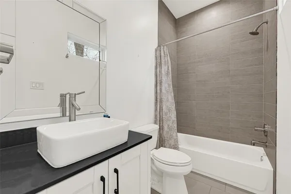 a living room with furniture and kitchen view