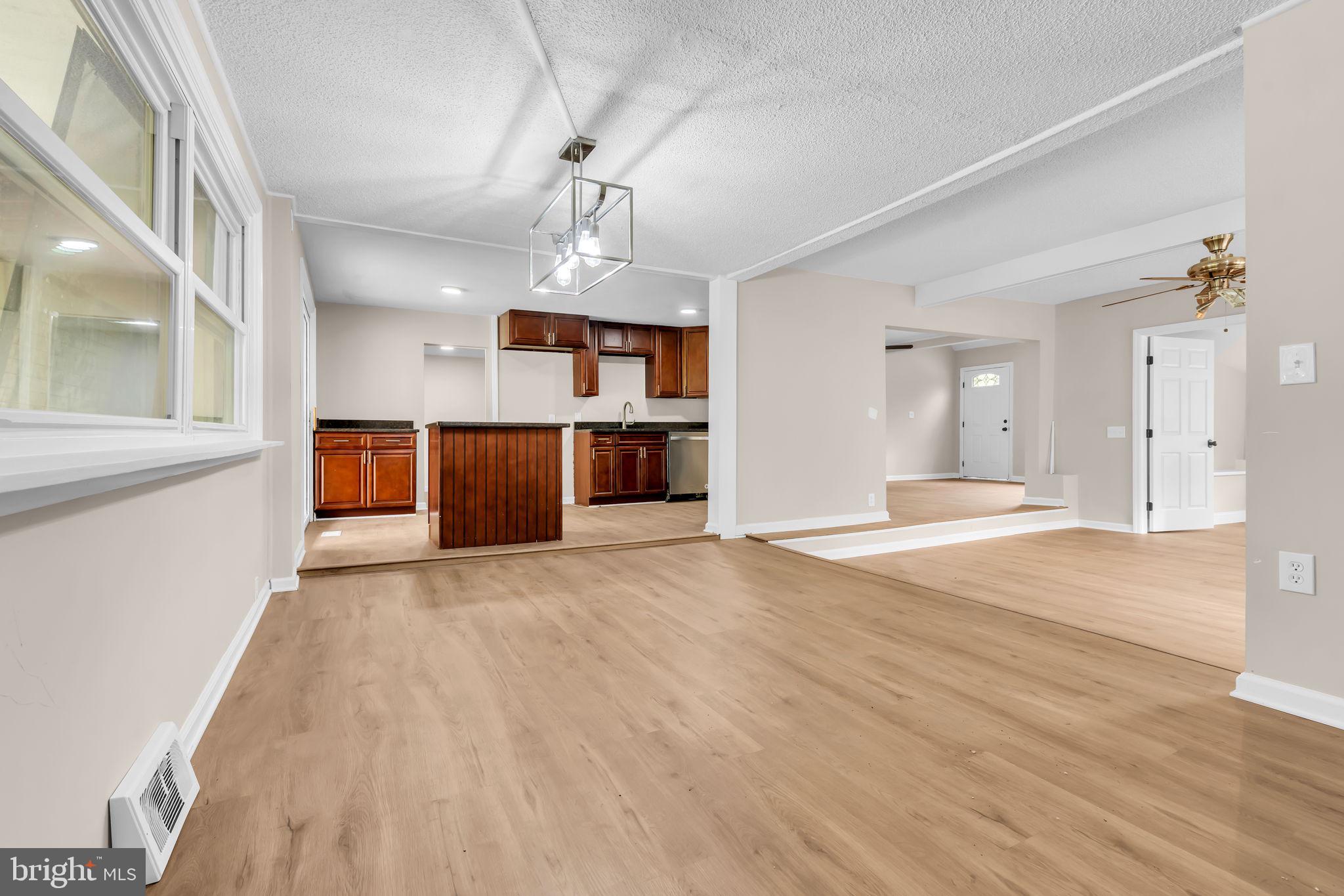 2438 Range Road Browns Mills, NJ 08015 - Photo 20 of 61 a view of a big room with wooden floor and kitchen view