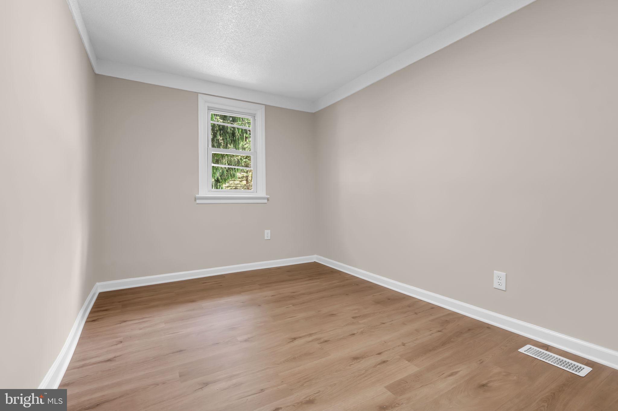 2438 Range Road Browns Mills, NJ 08015 - Photo 30 of 61 an empty room with wooden floor and windows