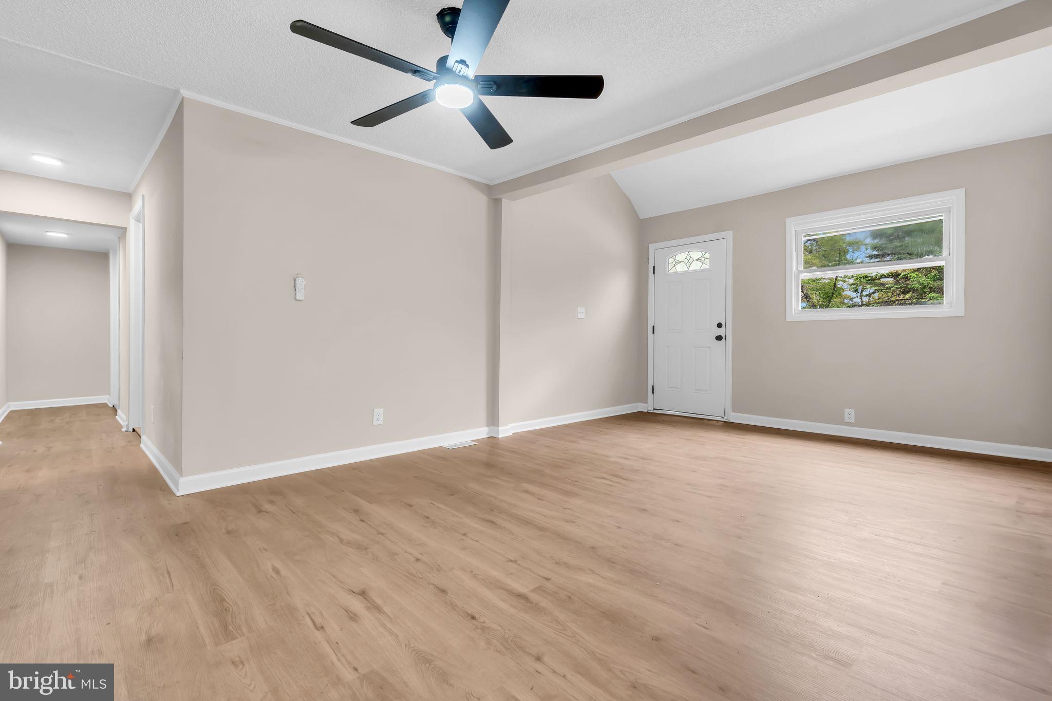 2438 Range Road Browns Mills, NJ 08015 - Photo 10 of 61 an empty room with wooden floor and ceiling fan