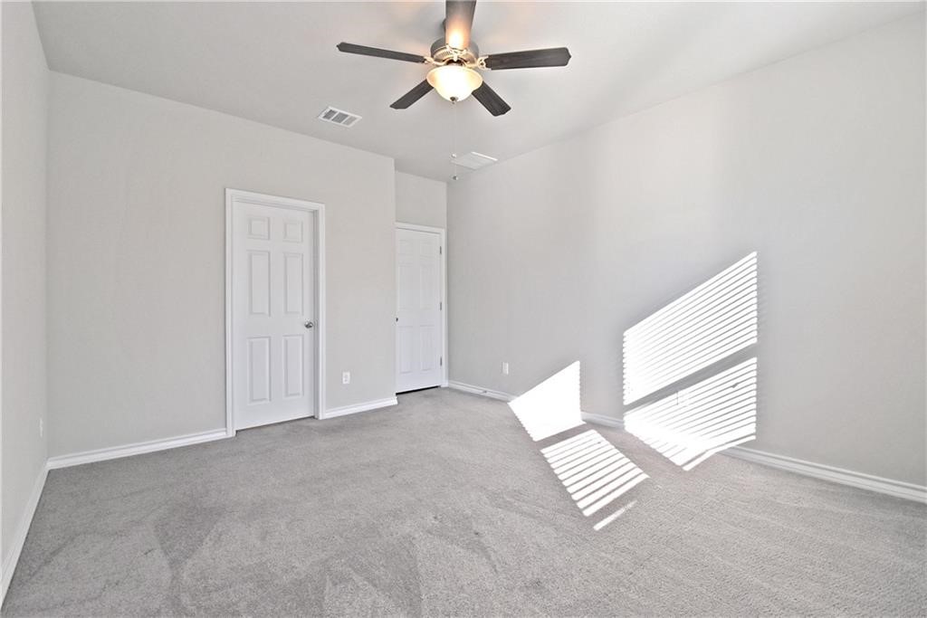 1220 Natchez Trail Leander, TX 78641 - Photo 11 of 13 an empty room with windows and fan