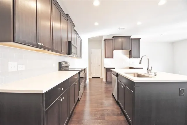a kitchen with sink cabinets and stove