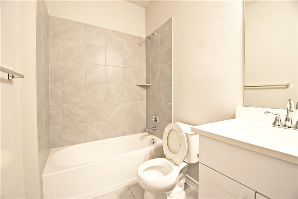 1220 Natchez Trail Leander, TX 78641 - Photo 10 of 13 a bathroom with a sink a toilet and a bathtub