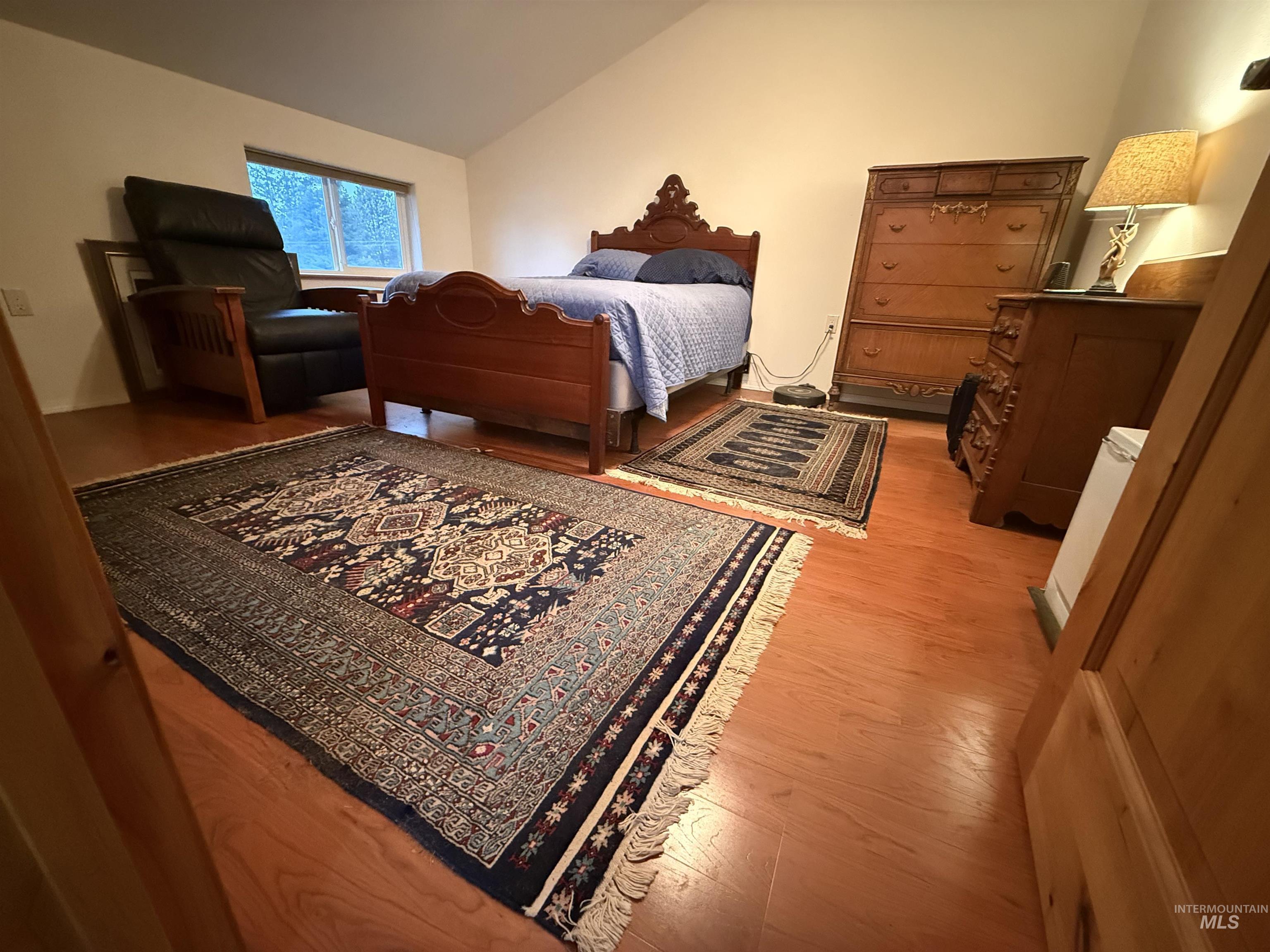 1653 Kidder Ridge Road Kamiah, ID 83536 - Photo 17 of 47 Bedroom with vaulted ceiling and light wood-style floors