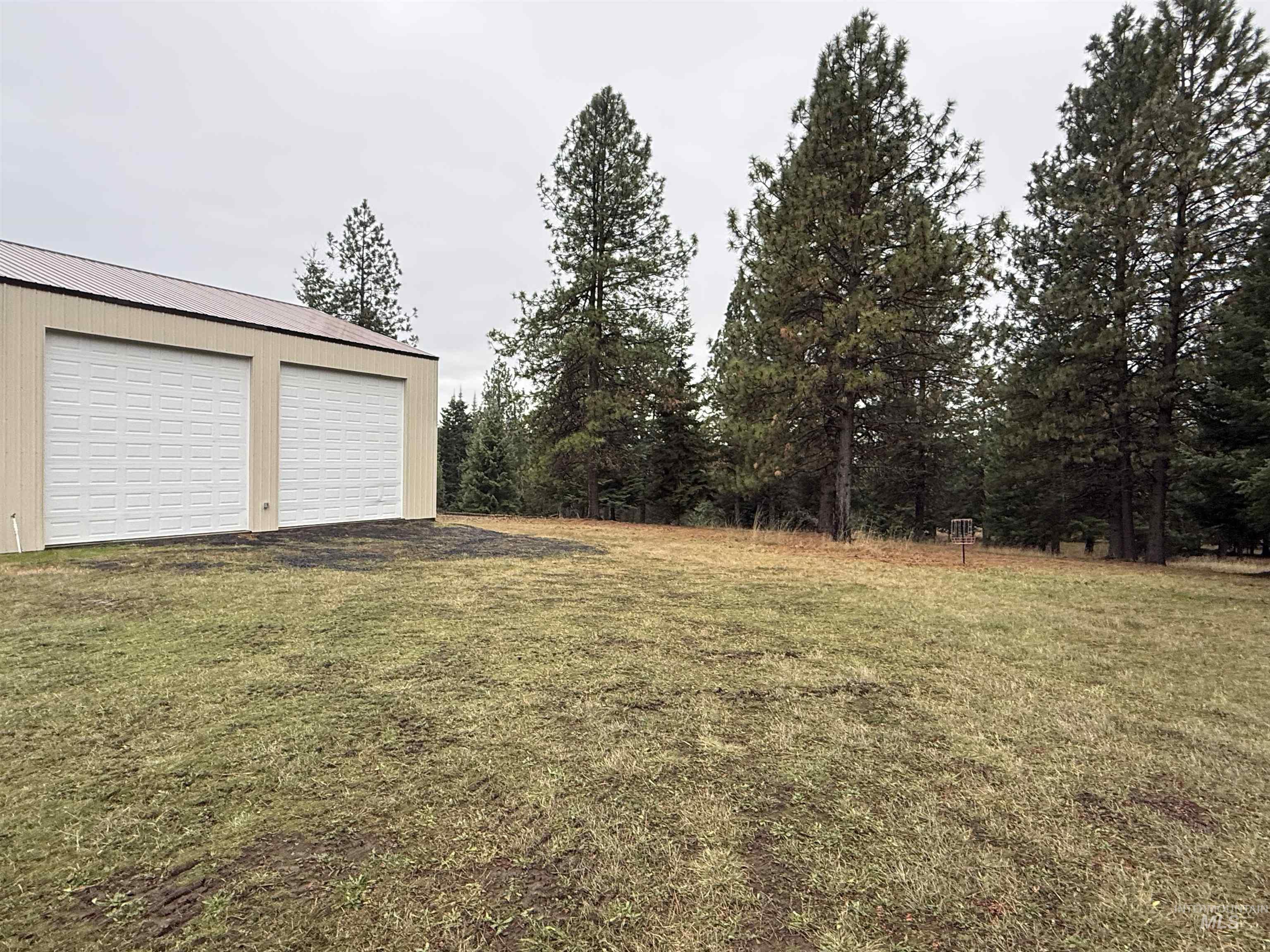 1653 Kidder Ridge Road Kamiah, ID 83536 - Photo 35 of 47 View of green lawn featuring an outbuilding and a garage