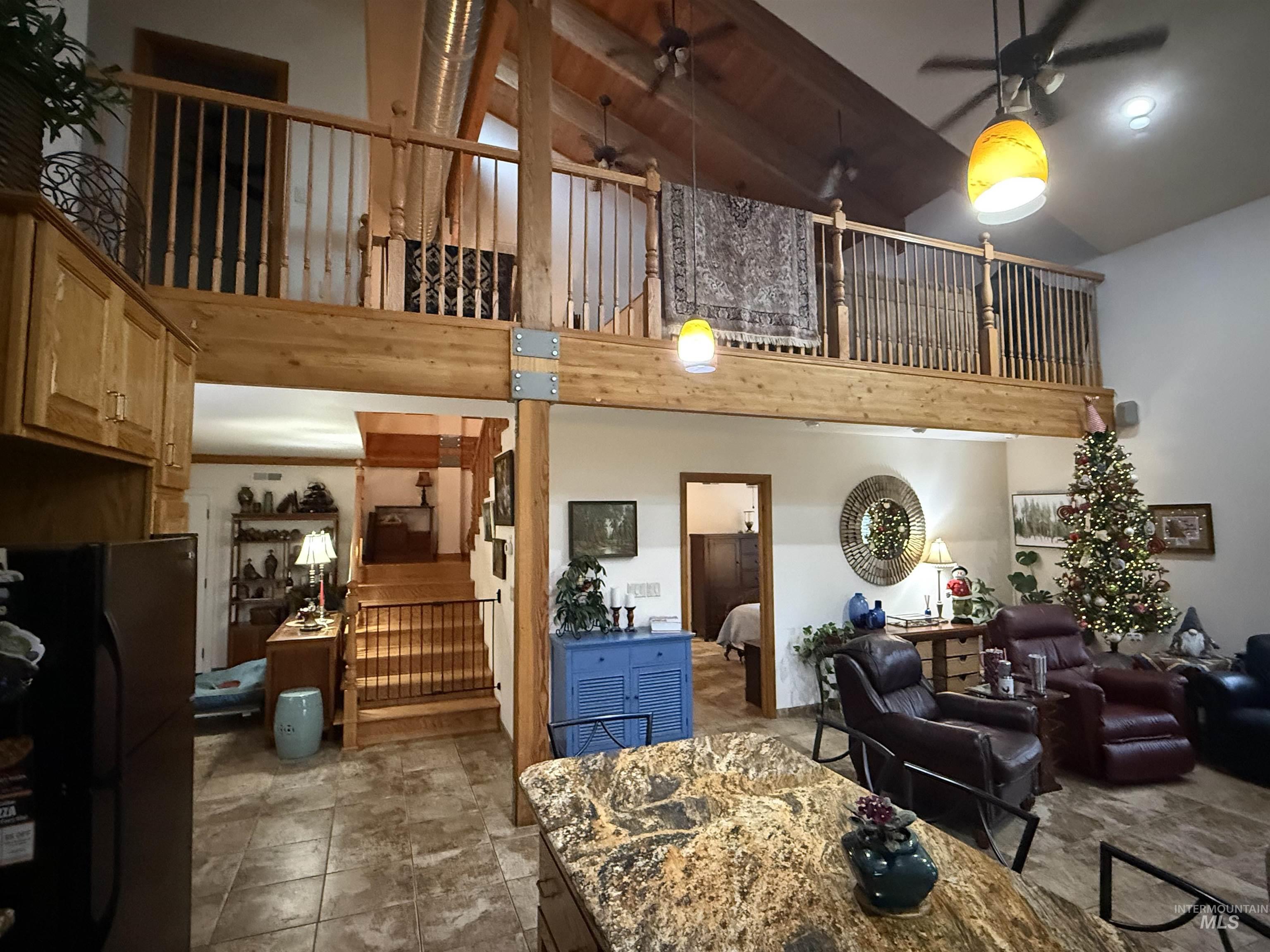 1653 Kidder Ridge Road Kamiah, ID 83536 - Photo 7 of 47 Living area with ceiling fan, stairway, and high vaulted ceiling
