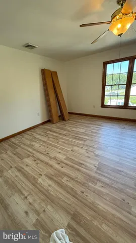 a view of a room with wooden floor and stairs