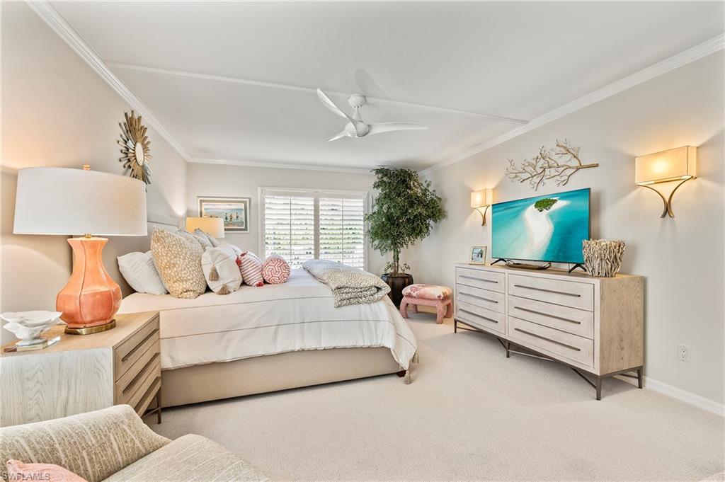 4155 Crayton Road, Unit 107 Naples, FL 34103 - Photo 26 of 36 Carpeted bedroom featuring ornamental molding and ceiling fan
