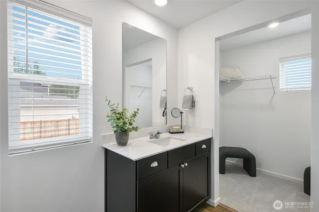 a view of a room with wooden floor and white walls
